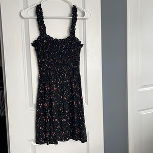 Adorable black floral mini dress! Gathered top and shoulder detail